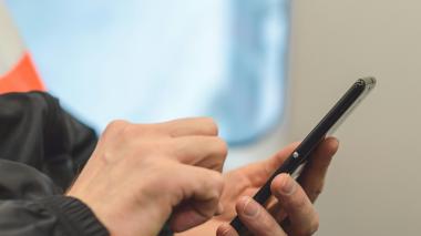 young man's hands using a mobile